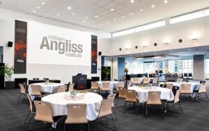 photo of the conference room at William Angliss Institute with round tables and the large screen